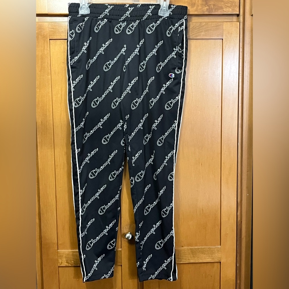 Women’s Champion track pants with all over logo & zippered bottom leg size small